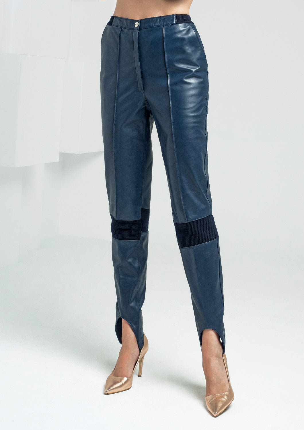 High-waisted trousers with bands under the legs